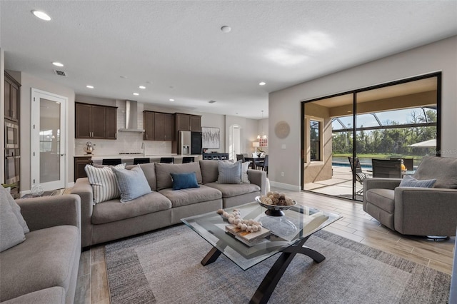 12654 Oak Hill Way, Parrish, FL 34219 - living area with light wood-type flooring, recessed lighting, baseboards, and a textured ceiling