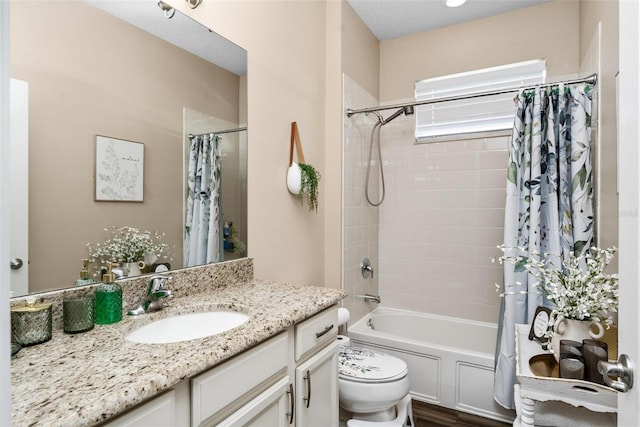 bathroom featuring vanity, shower / tub combo, and toilet