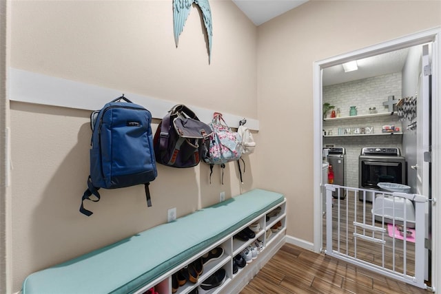 mudroom featuring separate washer and dryer and wood finished floors