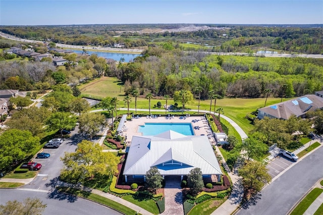 drone / aerial view featuring a forest view and a water view