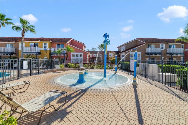 view of pool with a residential view and fence