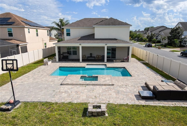 view of pool with a yard, a patio, a pool with connected hot tub, and a fenced backyard