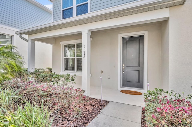 property entrance featuring stucco siding