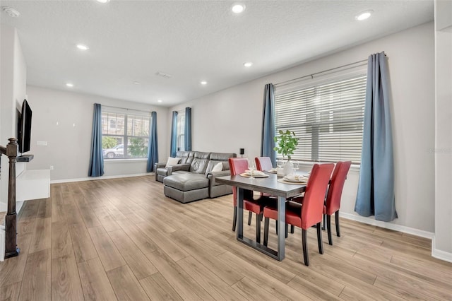 dining room with light wood-style flooring, recessed lighting, and baseboards