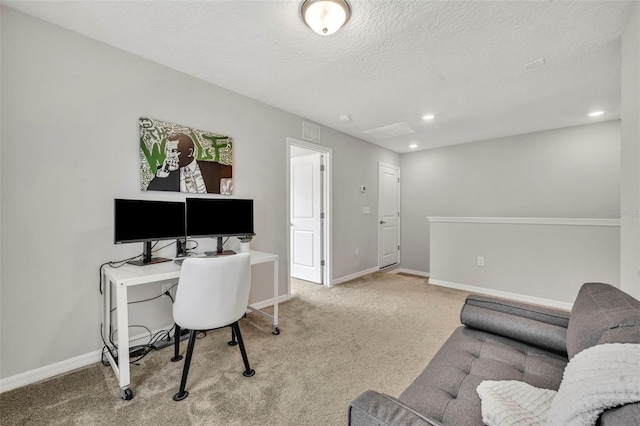 office area featuring a textured ceiling, carpet, visible vents, and baseboards