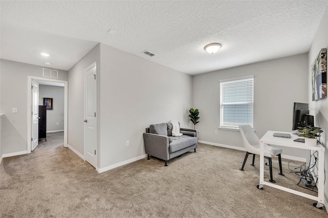 office featuring visible vents, a textured ceiling, baseboards, and carpet