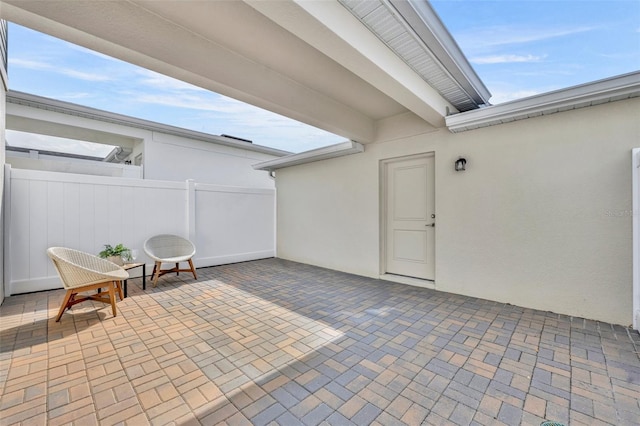 view of patio featuring fence