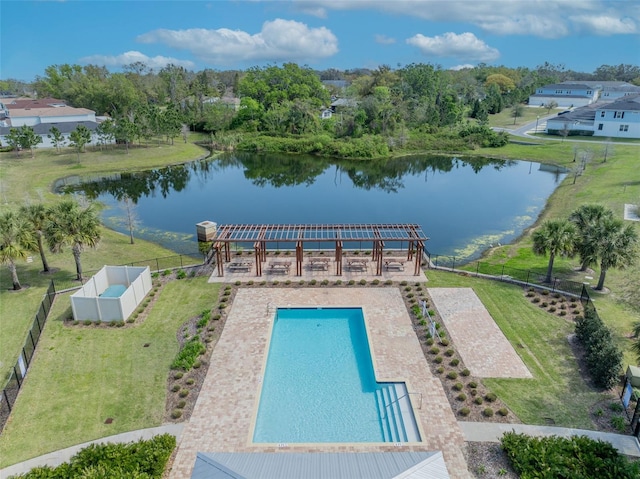 view of pool with fence, a yard, and a water view