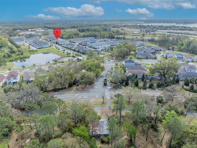 drone / aerial view featuring a residential view and a water view