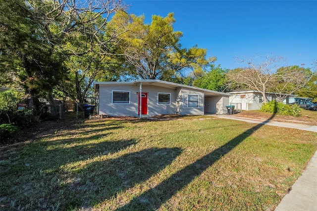 view of front of house featuring driveway, a front yard, and an attached carport