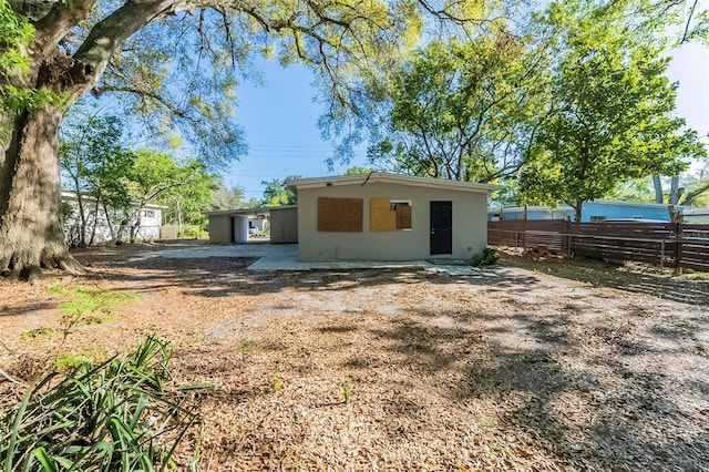 rear view of house with fence
