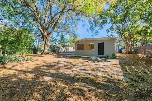 rear view of property with a fenced backyard