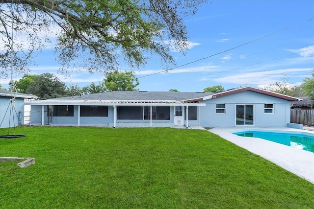 back of house with an outdoor pool, a yard, fence, and a sunroom