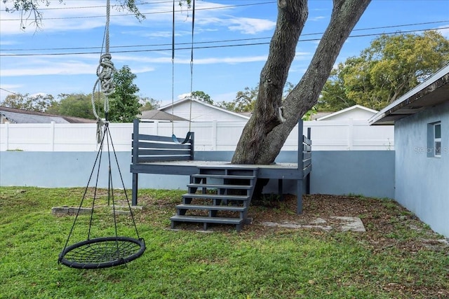 view of yard featuring stairway, a deck, and a fenced backyard