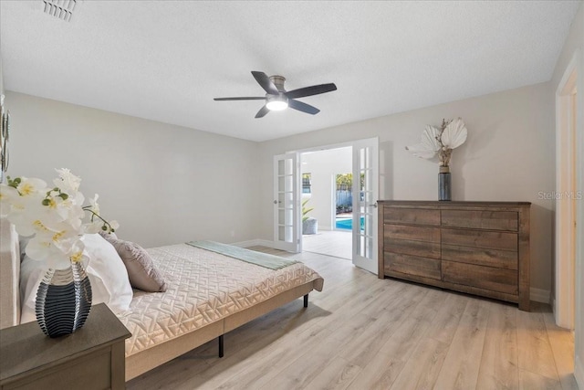 bedroom with visible vents, french doors, light wood-style floors, baseboards, and access to exterior