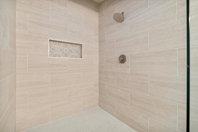 bathroom with tiled shower