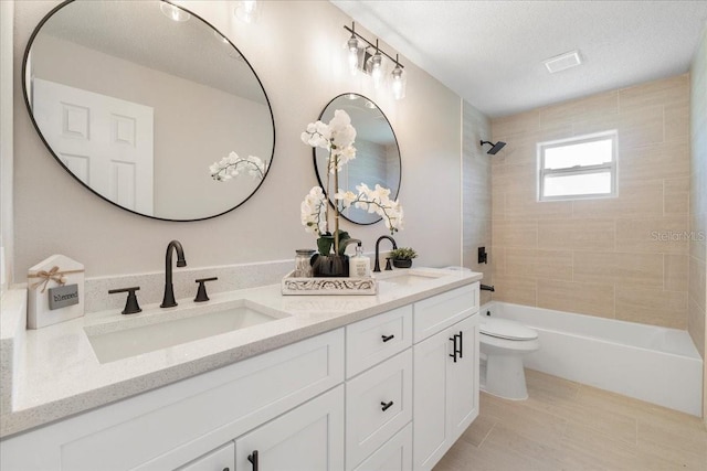 full bathroom featuring double vanity, toilet, bathing tub / shower combination, and a sink