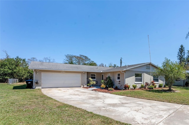 ranch-style house with a garage, concrete driveway, and a front lawn