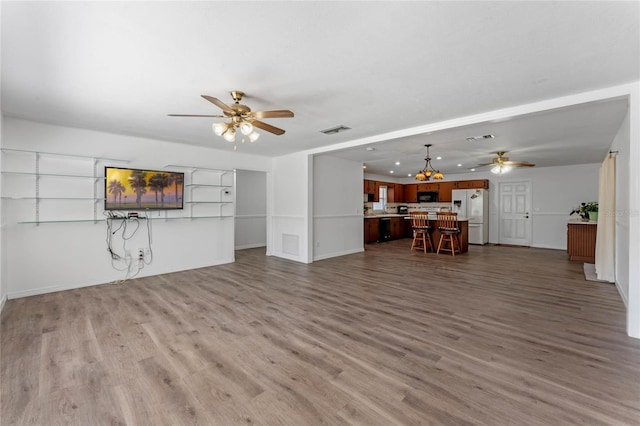 1021 Mare Bello Dr, Winter Park, FL 32792 - living area with baseboards, visible vents, wood finished floors, and ceiling fan with notable chandelier
