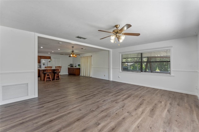 1021 Mare Bello Dr, Winter Park, FL 32792 - unfurnished living room with baseboards, ceiling fan, visible vents, and wood finished floors