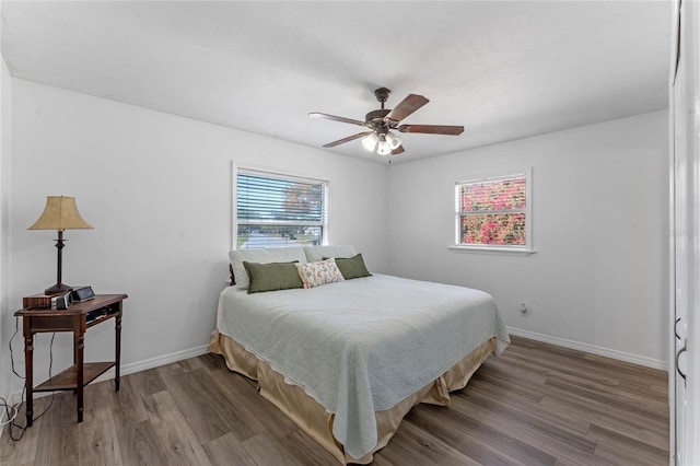 1021 Mare Bello Dr, Winter Park, FL 32792 - bedroom with baseboards, a ceiling fan, and wood finished floors