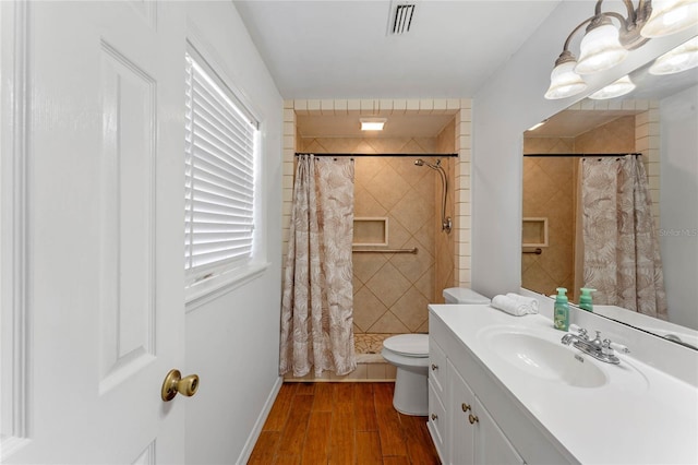 1021 Mare Bello Dr, Winter Park, FL 32792 - bathroom featuring visible vents, a tile shower, wood finished floors, vanity, and toilet