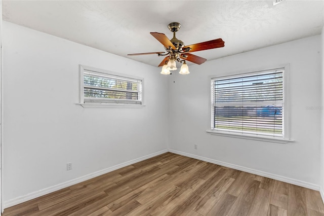 1021 Mare Bello Dr, Winter Park, FL 32792 - spare room with baseboards, ceiling fan, and wood finished floors