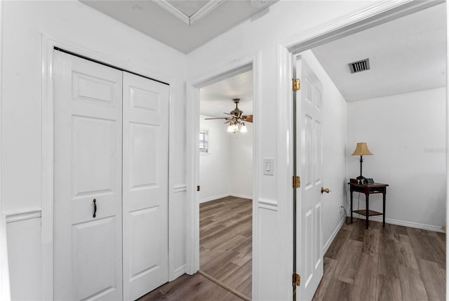 1021 Mare Bello Dr, Winter Park, FL 32792 - corridor featuring crown molding, baseboards, visible vents, and wood finished floors