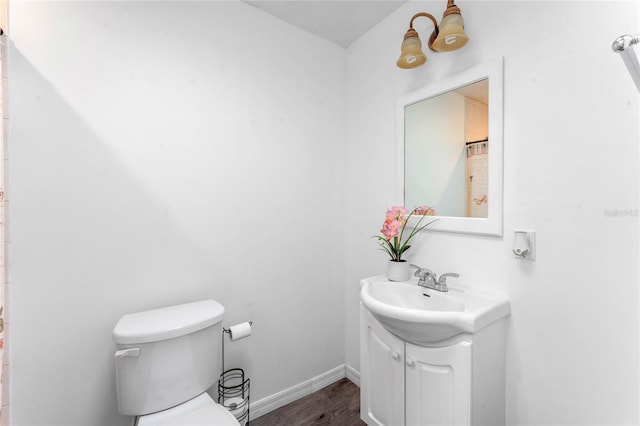 1021 Mare Bello Dr, Winter Park, FL 32792 - bathroom with toilet, baseboards, wood finished floors, and vanity