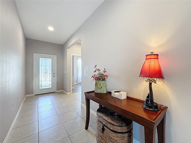 entryway featuring light tile patterned floors and baseboards