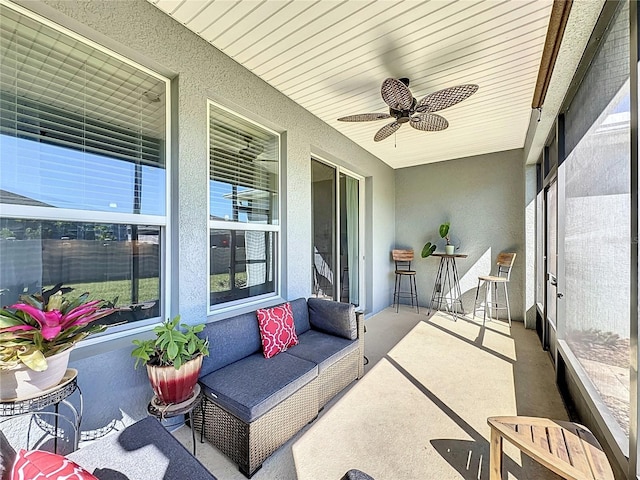 sunroom / solarium featuring a ceiling fan