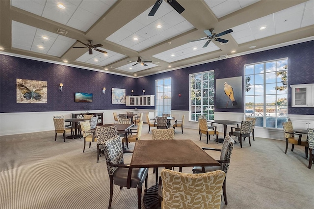 carpeted dining area with visible vents, coffered ceiling, beam ceiling, ceiling fan, and wainscoting