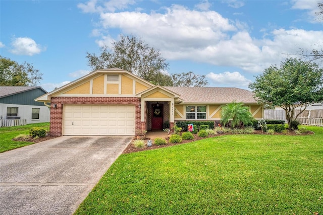 view of front of house with brick siding, concrete driveway, a front yard, and fence