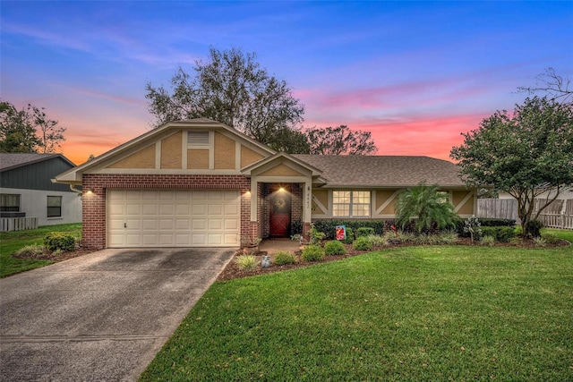 view of front facade featuring brick siding, an attached garage, concrete driveway, and a front lawn