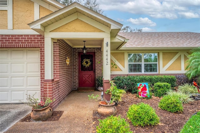 property entrance featuring stucco siding, brick siding, and an attached garage