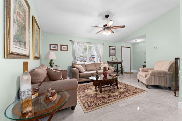 living room with lofted ceiling, a ceiling fan, and baseboards