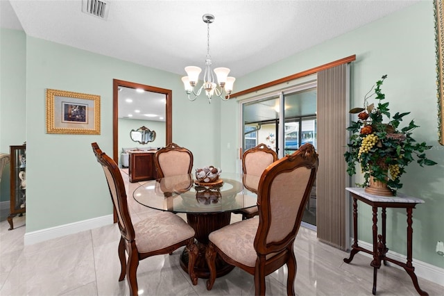 dining space featuring baseboards, visible vents, and a chandelier