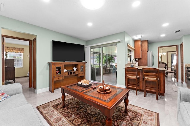 living area featuring recessed lighting, visible vents, baseboards, and light tile patterned flooring