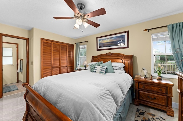 bedroom featuring a closet, a textured ceiling, and a ceiling fan