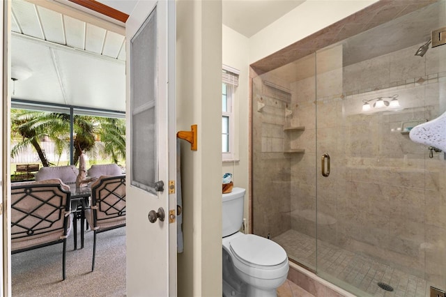 bathroom with toilet and a stall shower