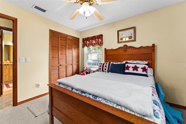 bedroom featuring visible vents, ceiling fan, baseboards, carpet floors, and a closet