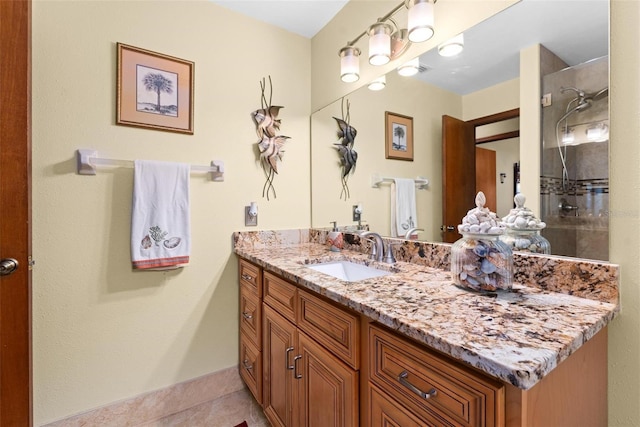 bathroom featuring a shower and vanity