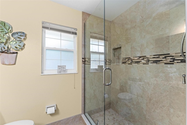 full bathroom with toilet and a stall shower