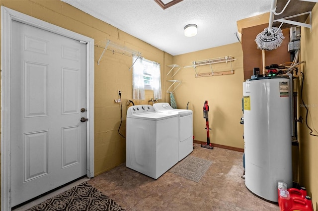 laundry area featuring a textured ceiling, washing machine and dryer, laundry area, and water heater