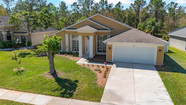 view of front of home featuring concrete driveway, an attached garage, a front yard, and stucco siding