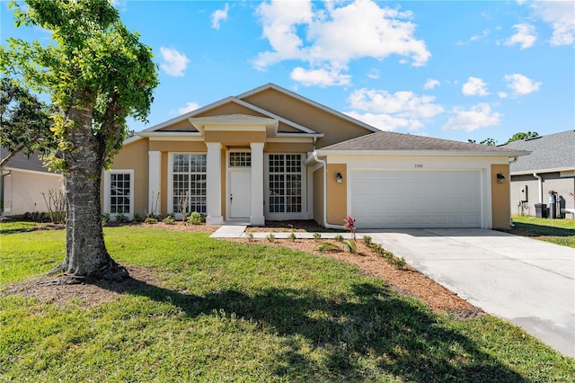 view of front of home with stucco siding, a front yard, concrete driveway, and an attached garage