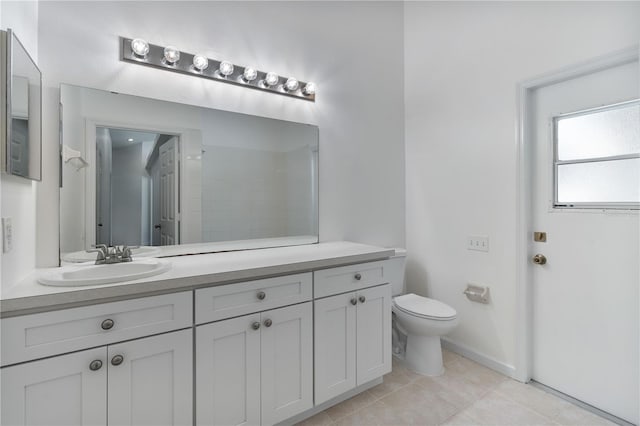 full bathroom featuring vanity, tile patterned floors, and toilet