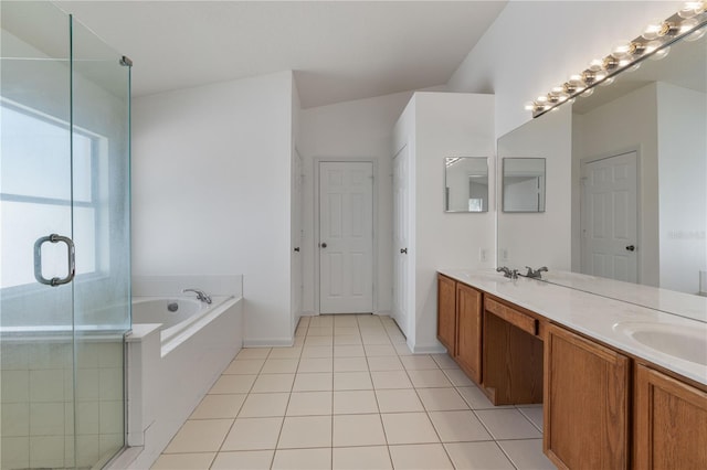 bathroom featuring tile patterned floors, a garden tub, a sink, a shower stall, and double vanity