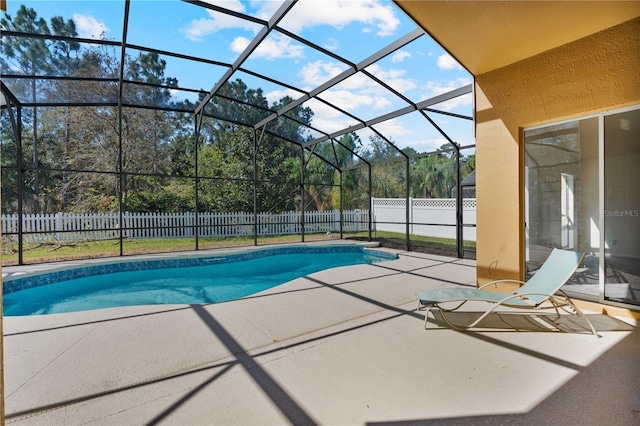 view of pool featuring a fenced in pool, a patio, glass enclosure, and a fenced backyard