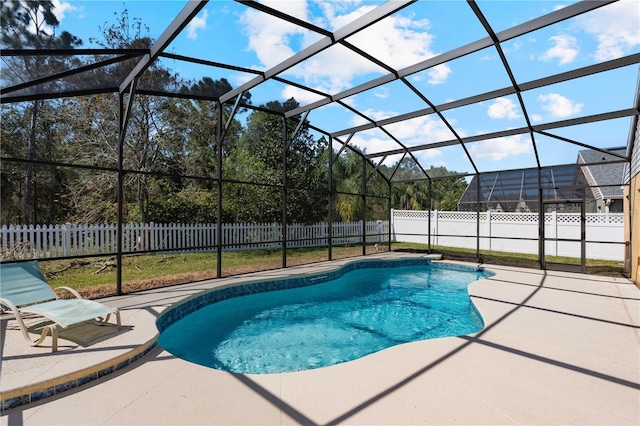 view of swimming pool with a fenced in pool, a patio, glass enclosure, and a fenced backyard